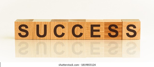 SUCCESS message word written on wood block. success message text on wooden table for your desing, Top view concept