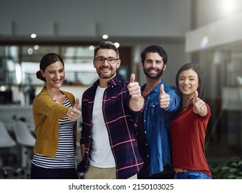 Success Is Our Middle Name. Portrait Of A Group Of Businesspeople Showing Thumbs Up.