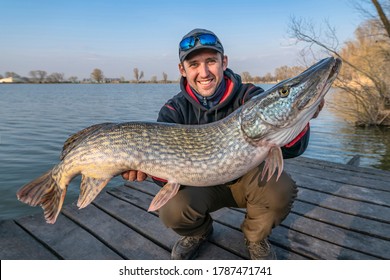 Success pike fishing. Happy fisherman with big fish trophy in hands - Shutterstock ID 1787471741