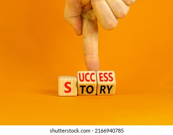 Success Story Symbol. Concept Words Success Story On Wooden Cubes. Businessman Hand. Beautiful Orange Table Orange Background. Business And Success Story Concept. Copy Space.