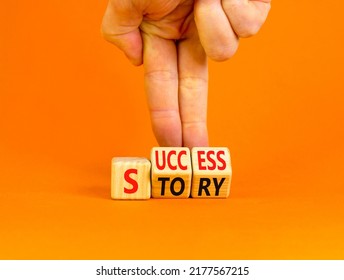 Success Story Symbol. Concept Words Success Story On Wooden Cubes. Businessman Hand. Beautiful Orange Table Orange Background. Business And Success Story Concept. Copy Space.