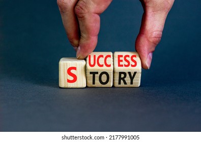 Success Story Symbol. Concept Words Success Story On Wooden Cubes. Businessman Hand. Beautiful Grey Table Grey Background. Business And Success Story Concept. Copy Space.