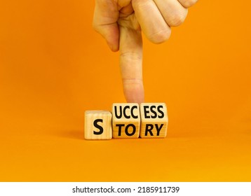 Success Story Symbol. Concept Words Success Story On Wooden Cubes. Businessman Hand. Beautiful Orange Table Orange Background. Business And Success Story Concept. Copy Space.