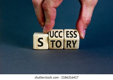 Success Story Symbol. Concept Words Success Story On Wooden Cubes. Businessman Hand. Beautiful Grey Table Grey Background. Business And Success Story Concept. Copy Space.