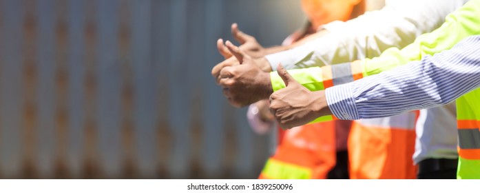 Success Team Of Foreman And Worker People Showing Thumbs Up Sign In Workplace. Container Yard Port Of Import And Export. Business Teamwork Concept