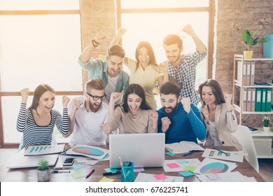 Success And Team Work Concept. Group Of Business Partners With Raised Up Hands In Light Modern Workstation, Celebrating The Breakthrough In Their Company