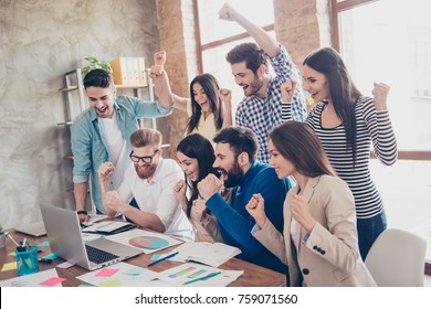 Success And Team Work Concept. Group Of Business Partners With Raised Up Hands In Light Modern Workstation, Celebrating The Breakthrough In Their Company