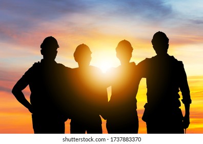 Success And Teamwork Concept, Silhouette Of Engineer And Worker Team With Clipping Path Standing With Hands On Shoulders Sunset Background