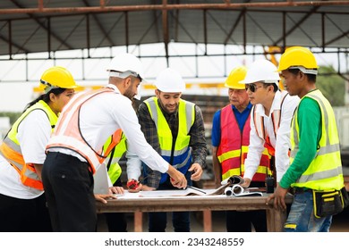 Success teamwork. Ethnic diversity worker people. Group of professional Construction engineering people wearing hardhat safety helmet meeting at Prefabricated concrete walls Industry Factory - Powered by Shutterstock