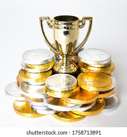 A Success Or Victory Concept With A Gold Trophy Or Cup Surrounded By Gold And Silver Coins In The Form Of Prize Money