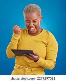 Success winner woman on tablet isolated on blue background fist pump, yes and cheers for online news. Winning, competition and giveaway prize for african person on digital tech celebration in studio - Shutterstock ID 2279297081
