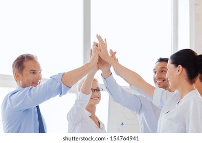 Success And Winning Concept - Happy Business Team Giving High Five In Office