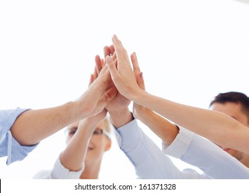 success and winning concept - happy business team giving high five in office