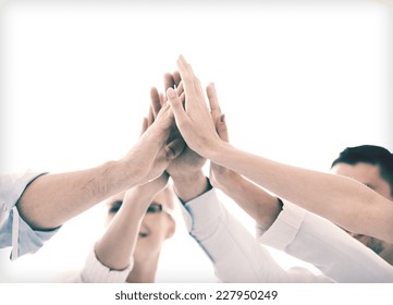 Success And Winning Concept - Happy Business Team Giving High Five In Office