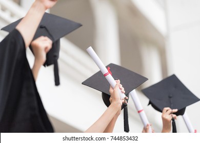Success Women are Celebrating Graduation Put Hand Up, a Certificate and a Hat in hand, Happiness Feeling, Commencement Day.Congratulated the Graduates in University.Graduation Ceremony Day Concept.
