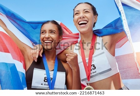 Success, women and running team with a flag in celebration of winners medals achievement at a sports event. Fitness, British and happy athlete runners excited to celebrate winning gold with pride