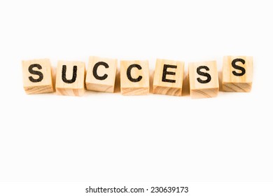Success words made out of alphabet wood pieces isolated on white - Shutterstock ID 230639173