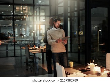 Success is worth all the late nights. Shot of a handsome young designer working late in the office. - Powered by Shutterstock