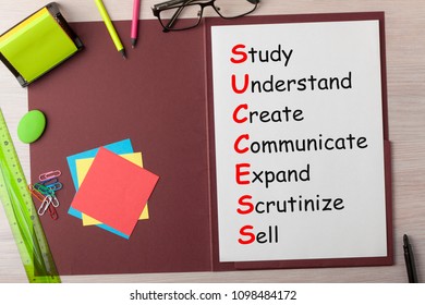 Success written on paper sheet in presentation folder and various stationery.  - Shutterstock ID 1098484172