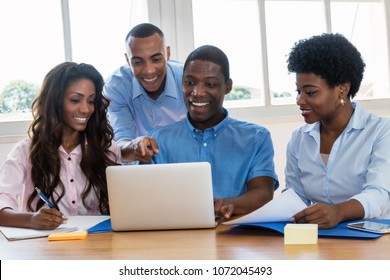 Successful African American Business Team Talking About Strategy At Office