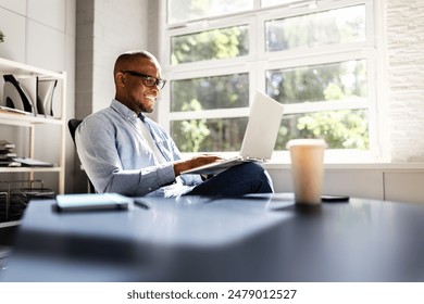 Successful African American Businessman Leading Team in Analyzing Market Trends and Utilizing Technology in Modern Office Setting - Powered by Shutterstock