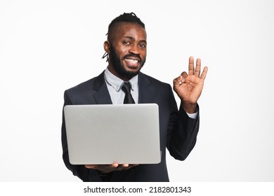 Successful African Businessman Ceo Leader Boss Bank Manager Showing Okay Gesture Using Laptop For E-banking E-commerce, E-learning, Watching Webinars Isolated In White Background