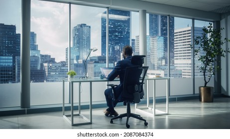 Successful African-American Businessman Sitting at His Desk Working on Laptop Computer in His Big City Office. Handsome Corporation CEO Planning Investment Strategy for e-Commerce Project. - Shutterstock ID 2087084374