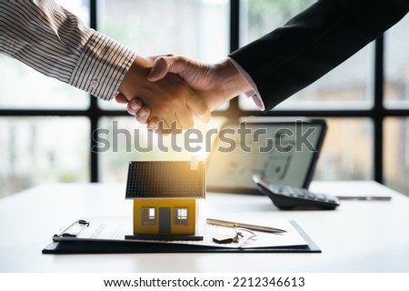 Successful agreement , estate,home buying contract concept, buyer shaking hand with bank empoyees after finishing signing contract in office