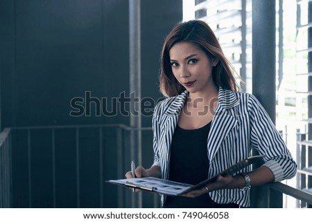 Successful Asia business woman looking confident and smiling