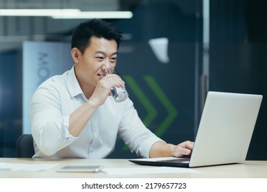 Successful Asian Businessman Working In Modern Office, Man Drinking Purified Water And Smiling