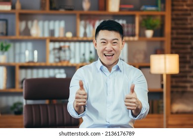 Successful Asian Man In Shirt Working Late In Classic Office, Portrait Of Happy Businessman Looking At Camera And Showing Thumbs Up