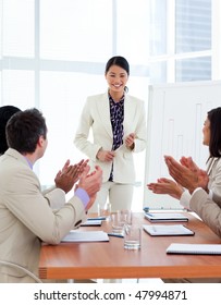 Successful Asian Woman Giving A Presentation In A Company