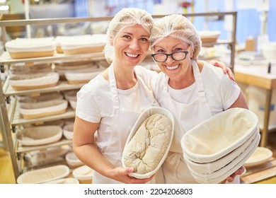 Successful Bakery Team With Apprentice And Baker With Experience In Baking Loaves Of Bread