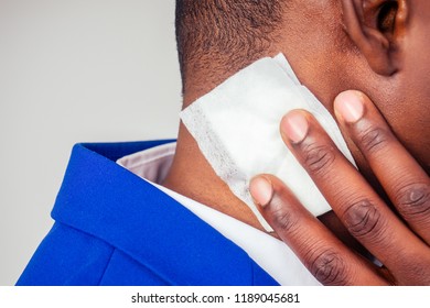 Successful And Beautiful American Afro Man In A Business Suit In A White Shirt Using Wet Wipes