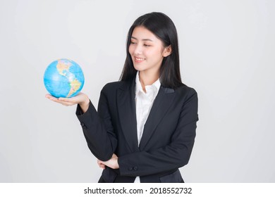 Successful Beautiful Asian Business Young Woman Holding Vintage Map Of The Globe World Map In Hand , Business Concept