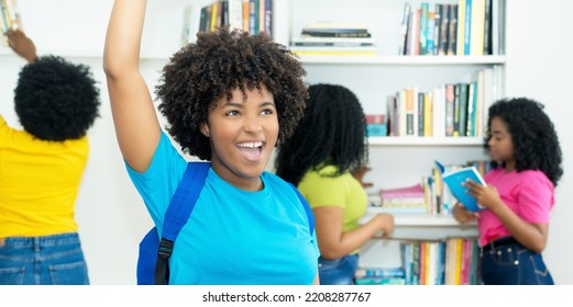 Successful Black Female Student With Group Of African American College Students Indoors At Library