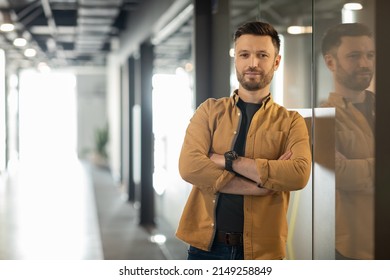 Successful Business Career. Confident Businessman Crossing Hands Posing Looking At Camera Standing In Doorway In Modern Office Indoors. Entrepreneurship And Employment Concept - Powered by Shutterstock