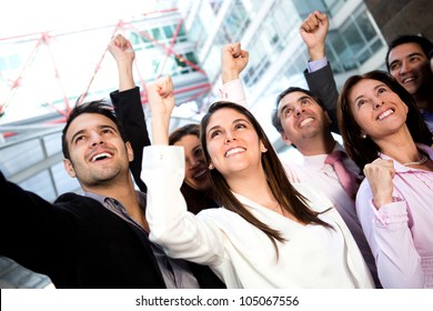 Successful Business Group Celebrating Their Triumph With Arms Up