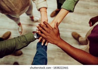 Successful business group hands stacked together showing unity and team work. - Powered by Shutterstock