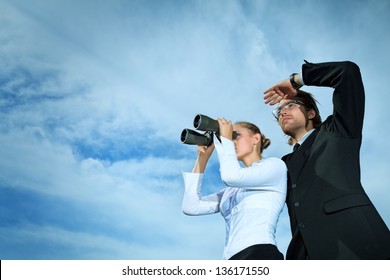 Successful business people  standing over blue sky and purposefully looking away.
