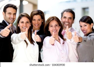 Successful Business People With Thumbs Up And Smiling
