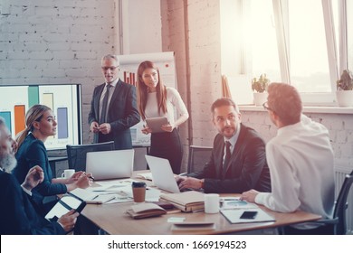 Successful business professionals presenting analytical report while working together with colleagues in the modern office - Shutterstock ID 1669194523