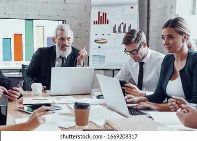 Successful business team analyzing strategy while working in the modern office - Shutterstock ID 1669208317