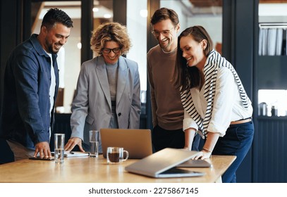 Successful business team connecting with their clients on a video call. Happy business people having an online meeting in an office. Networking and collaboration in a creative workplace. - Shutterstock ID 2275867145
