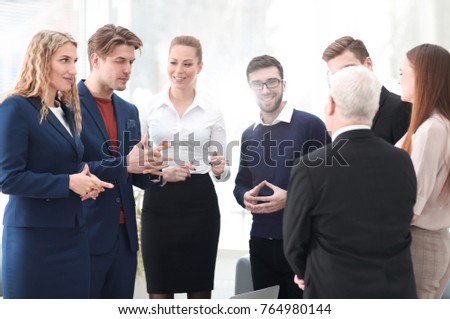 successful business team discussing documents and ideas standing near desktop