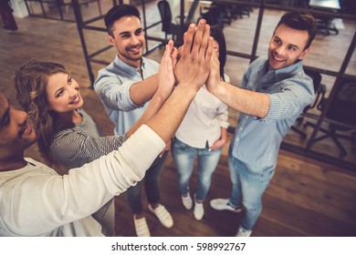 Successful Business Team Is Giving High Five And Smiling While Standing In Office