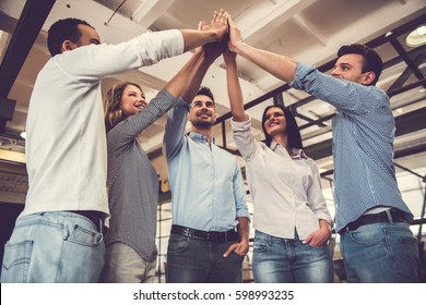 Successful Business Team Is Giving High Five And Smiling While Standing In Office