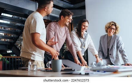 Successful business team working on a project in an advertising agency. Group of business people brainstorming in a meeting. Business professionals discussing ideas using sticky notes. - Powered by Shutterstock