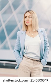 Successful Business Woman In Blue Suit. Beautiful Young Female Executive In An Urban Setting Near Office Building