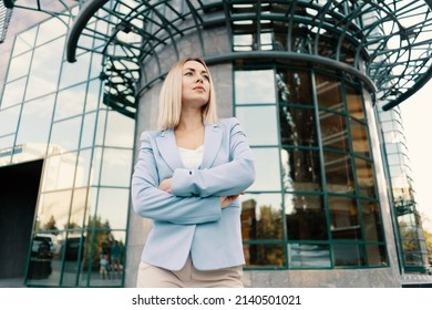 Successful Business Woman In Blue Suit. Beautiful Young Female Executive In An Urban Setting Near Office Building